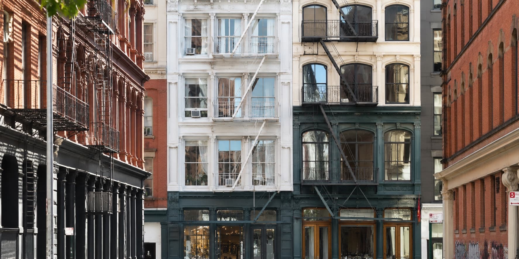 Cast-iron loft buildings with fire escapes on a SoHo street