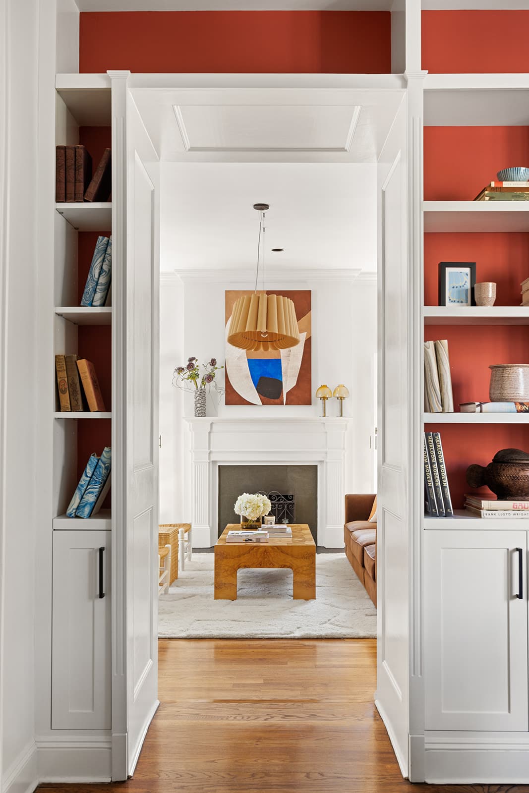 A doorway framed by built-in bookshelves, looking through to the living room