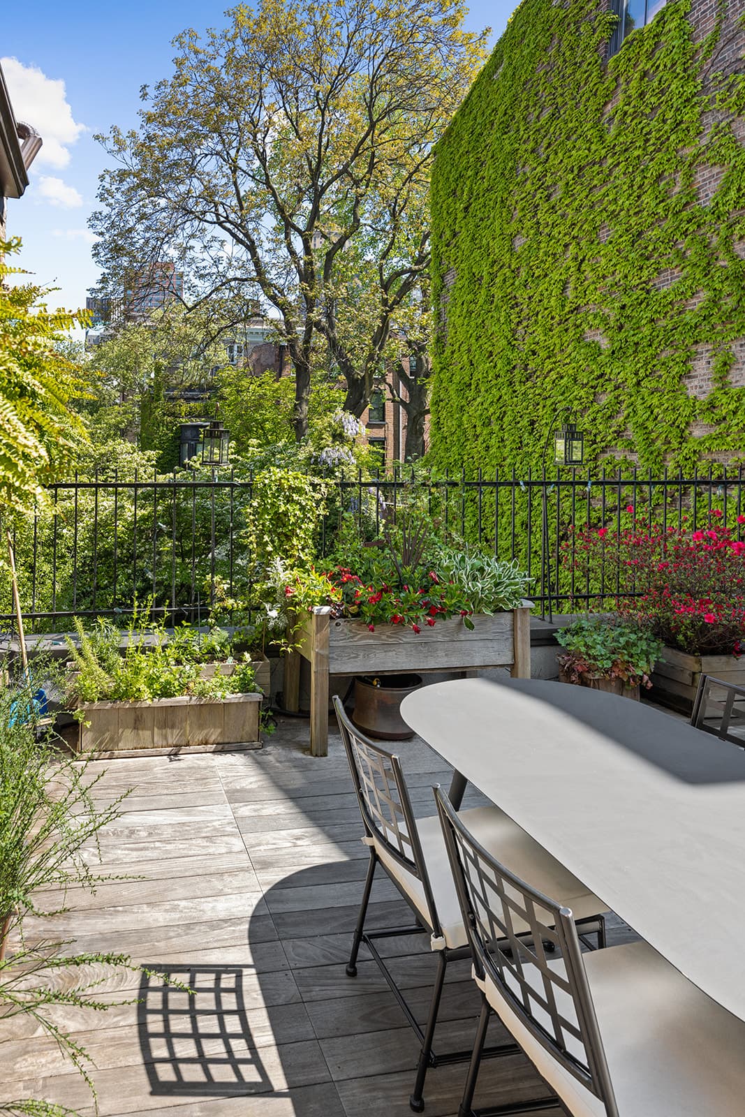 The terrace garden, with planters against an ivy-covered wall
