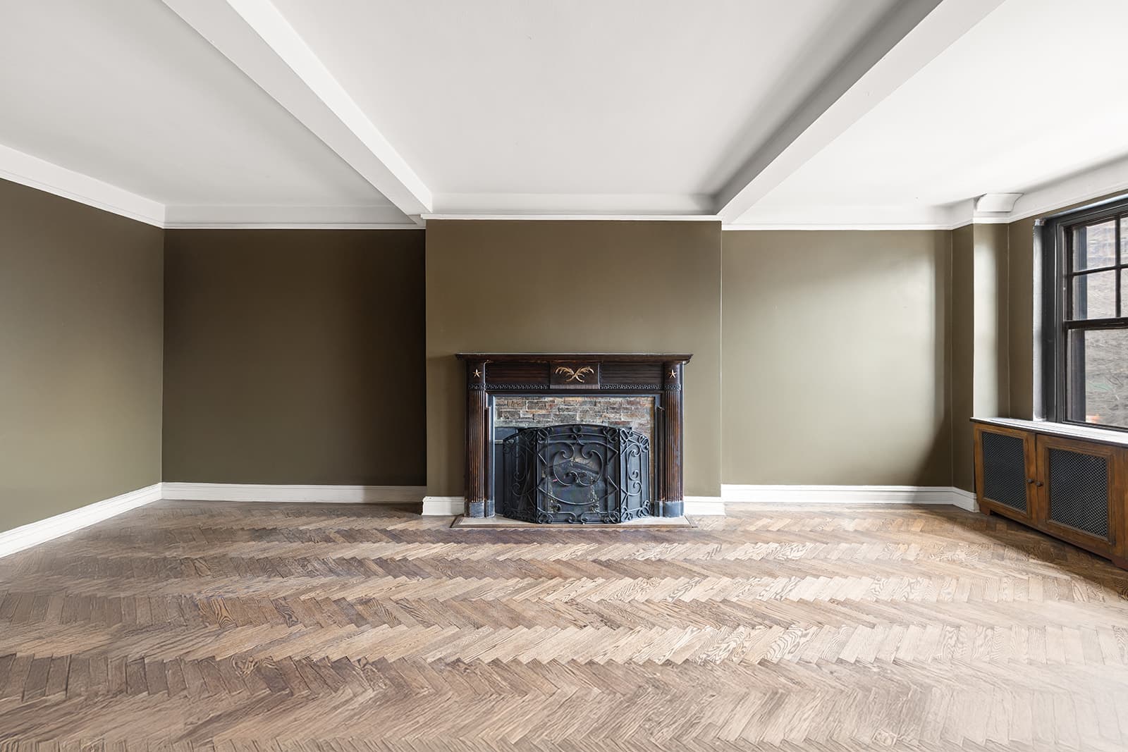 The living room fireplace wall and beamed ceiling
